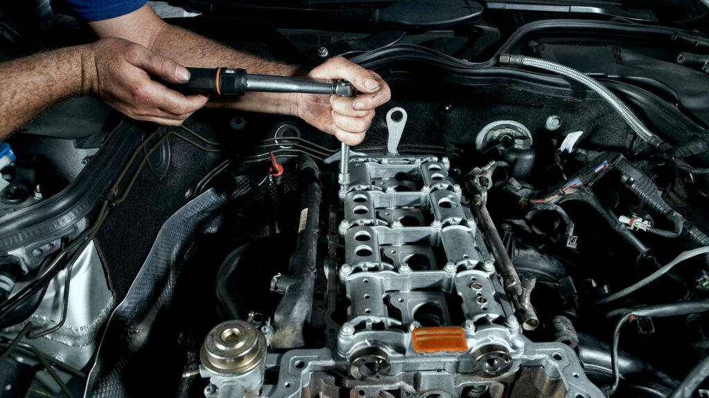 mechanic working on car engine