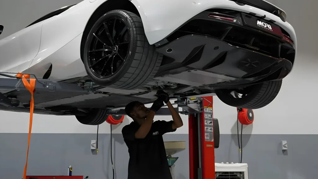 A luxury sports car lifted for tire inspection and alignment during professional tire services for premium vehicles
