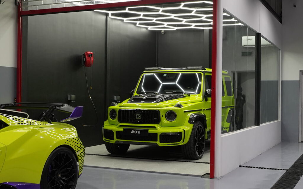 Luxury sports cars inside a modern auto care service center in Dubai