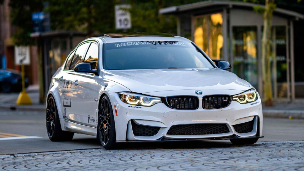 White BMW sedan on city street